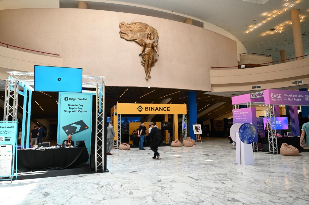 Conference expo floor with Binance and Bitget booths