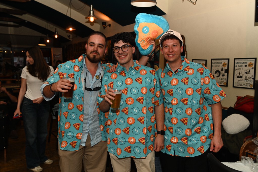 Three community members wearing Bitcoin Pizza Day shirts at a Balkans Crypto meetup